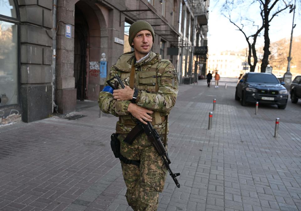 Former Ukrainian tennis player Sergiy Stakhovsky (pictured) walks with an assault rifle in Ukraine.