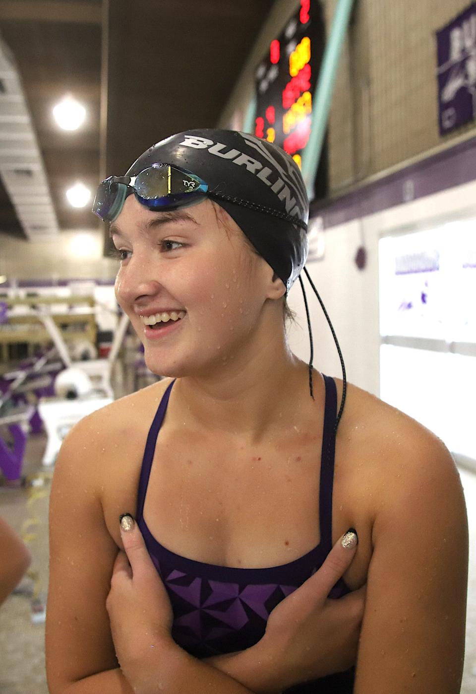 Burlington’s Jordyn Boyer smiles after the finish of the 200-yard freestyle relay during the Burlington Invitational Saturday in Burlington.