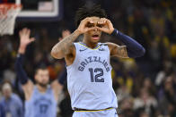 Memphis Grizzlies guard Ja Morant (12) reacts after an assist to center Jonas Valanciunas (17) in the second half of an NBA basketball game against the Los Angeles Lakers, Saturday, Feb. 29, 2020, in Memphis, Tenn. (AP Photo/Brandon Dill)