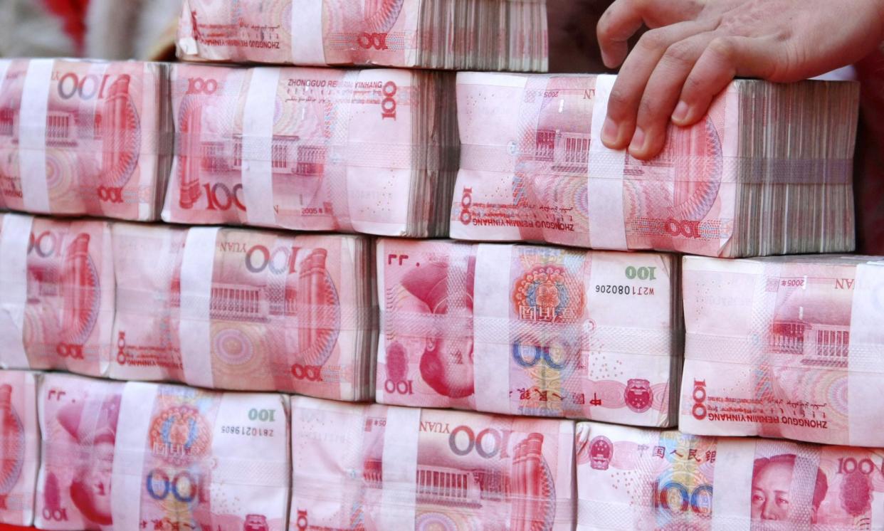 <span>Stacks of 100-yuan banknotes. China has signalled that it will slow the pace of its transition to a cashless society.</span><span>Photograph: Imaginechina/REX/Shutterstock</span>