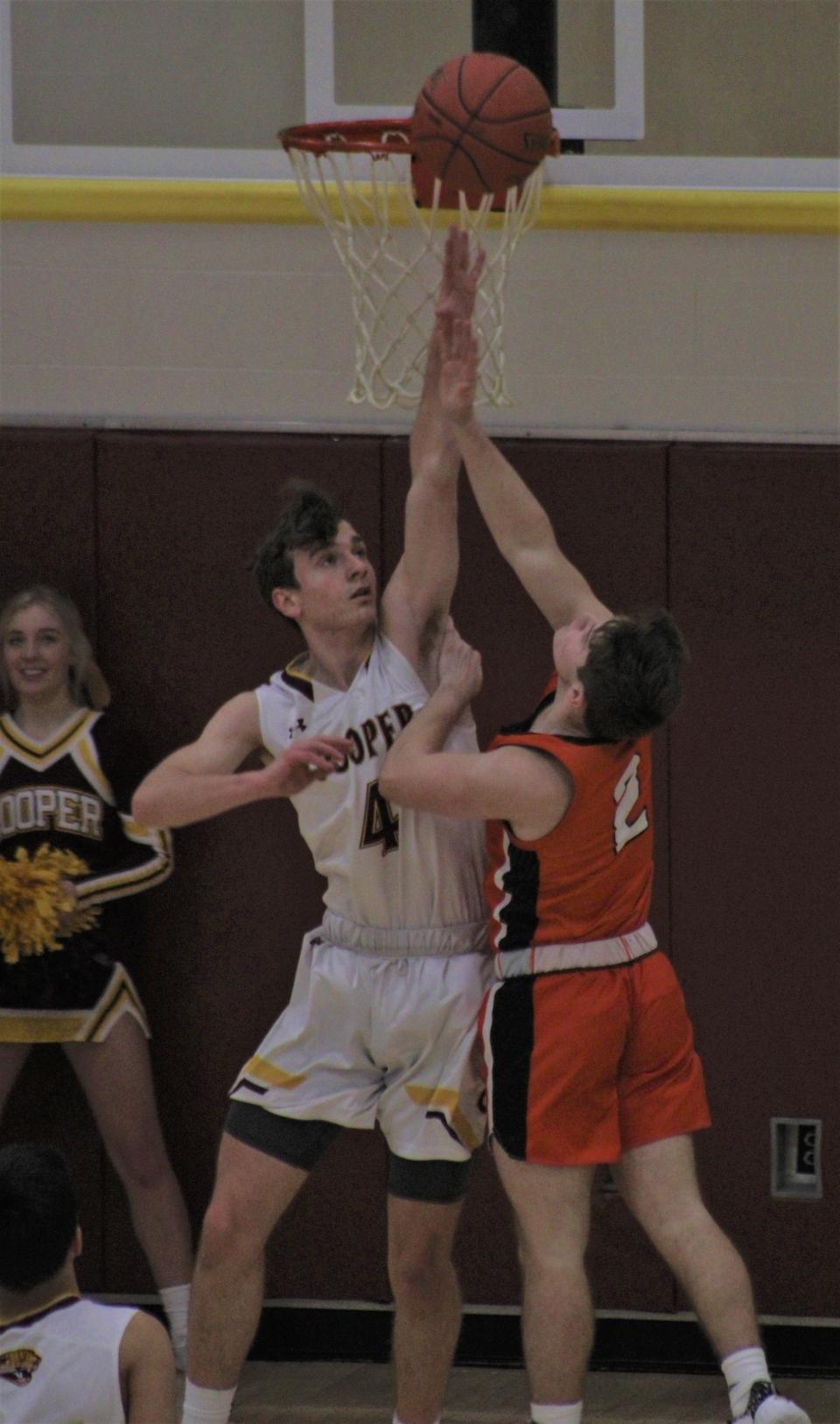 Cooper senior Blake Berry tries to block a shot from Ryle's Connor Bishop as Cooper defeated Ryle 52-45 Jan. 21.