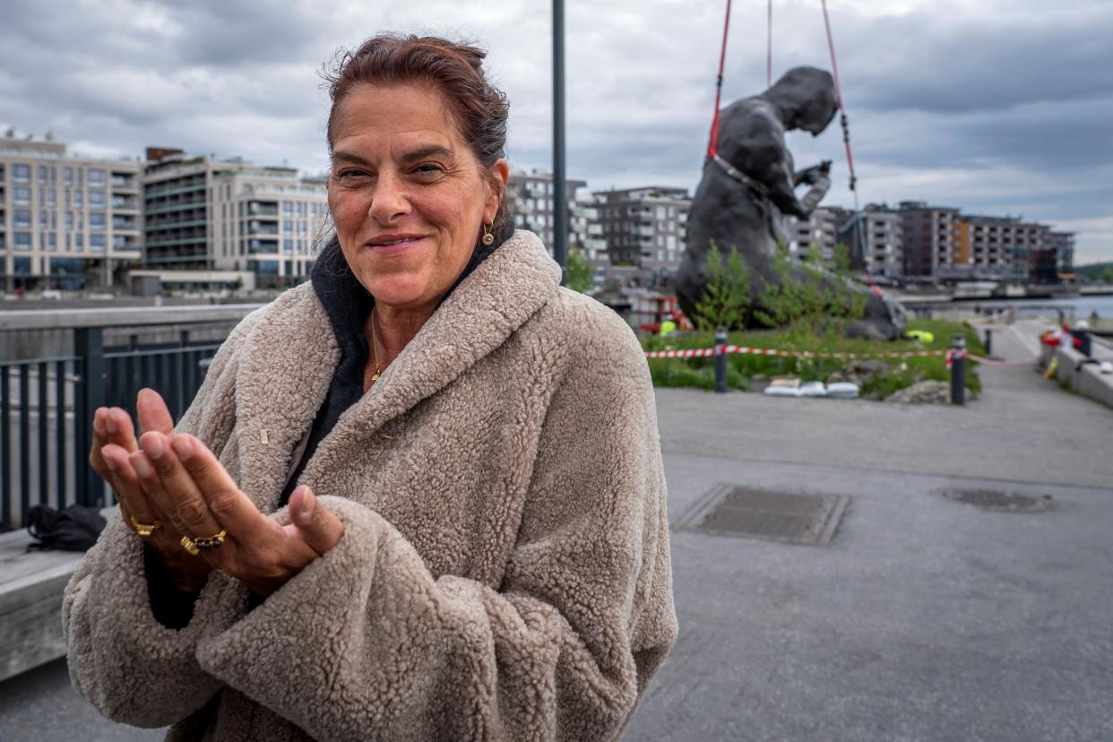 British artist Tracey Emin poses next to her sculpture 'The Mother' after it was moved by crane to its position outside The Munch Museum in Oslo, Norway, on June 2, 2022. - The nine-metre-high bronze sculpture weighing about 18 tonnes was shipped in parts from London and arrived with delay in Oslo. It will be placed at the Oslo waterfront, where it can be viewed by the public. The piece was created to honour the artist's mother and depicts a woman kneeling over an invisible child. - Norway OUT / RESTRICTED TO EDITORIAL USE - MANDATORY MENTION OF THE ARTIST UPON PUBLICATION - TO ILLUSTRATE THE EVENT AS SPECIFIED IN THE CAPTION (Photo by Heiko Junge / NTB / AFP) / Norway OUT / RESTRICTED TO EDITORIAL USE - MANDATORY MENTION OF THE ARTIST UPON PUBLICATION - TO ILLUSTRATE THE EVENT AS SPECIFIED IN THE CAPTION / Norway OUT / RESTRICTED TO EDITORIAL USE - MANDATORY MENTION OF THE ARTIST UPON PUBLICATION - TO ILLUSTRATE THE EVENT AS SPECIFIED IN THE CAPTION (Photo by HEIKO JUNGE/NTB/AFP via Getty Images)