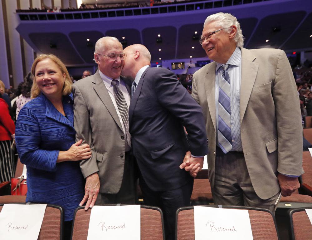 Outgoing New Orleans Mayor Mitch Landrieu kisses his father, former New Orleans Mayor Moon Landrieu, before they pose for a photo with his sister, former Sen. Mary Landrieu, D-La., and former New Orleans Mayor Sidney Barthelemy, right, before the inauguration of newly elected New Orleans Mayor Latoya Cantrell in New Orleans, Monday, May 7, 2018. (AP Photo/Gerald Herbert, File)