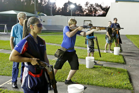 Reanna Frauens (L), 16, waits for her turn during a clay target youth group shooting meeting in Sunrise, Florida, U.S. February 26, 2018. Picture taken February 26, 2018. REUTERS/Joe Skipper