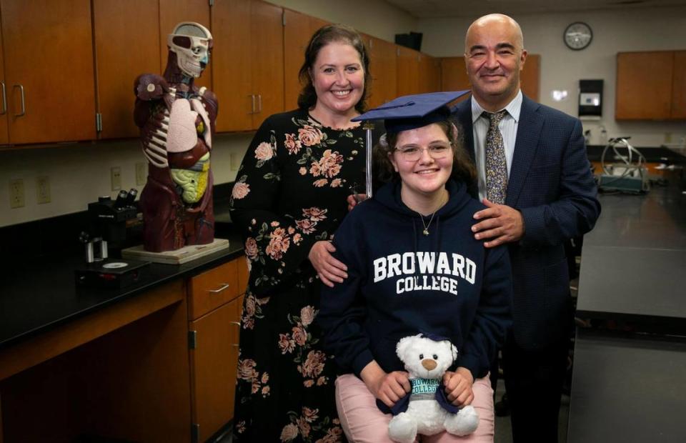 Sawsan Ahmed with her mom, Jeena Santos Ahmed, and dad, Wesam Ahmed in a biology lab at the Broward College on Dec. 13, 2021.