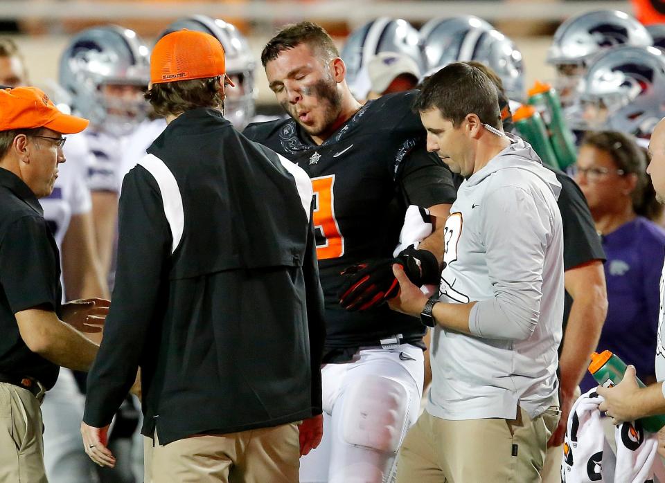 Oklahoma State defensive end Brock Martin reacts after dislocating his elbow last season against Kansas State.