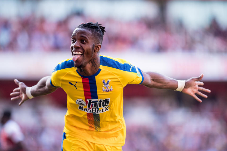 LONDON, ENGLAND - APRIL 21: Wilfried Zaha of Crystal Palace celebrates after scoring a goal during the Premier League match between Arsenal FC and Crystal Palace at Emirates Stadium on April 21, 2019 in London, United Kingdom. (Photo by Sebastian Frej/MB Media/Getty Images)