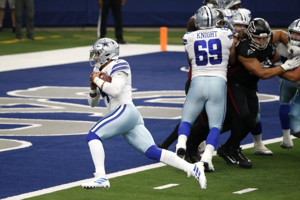 Dallas Cowboys quarterback Dak Prescott (4) reaches the end zone for a touchdown as Brandon Knight (69) provides coverage against the Atlanta Falcons in the second half of an NFL football game in Arlington, Texas, Sunday, Sept. 20, 2020. (AP Photo/Michael Ainsworth)