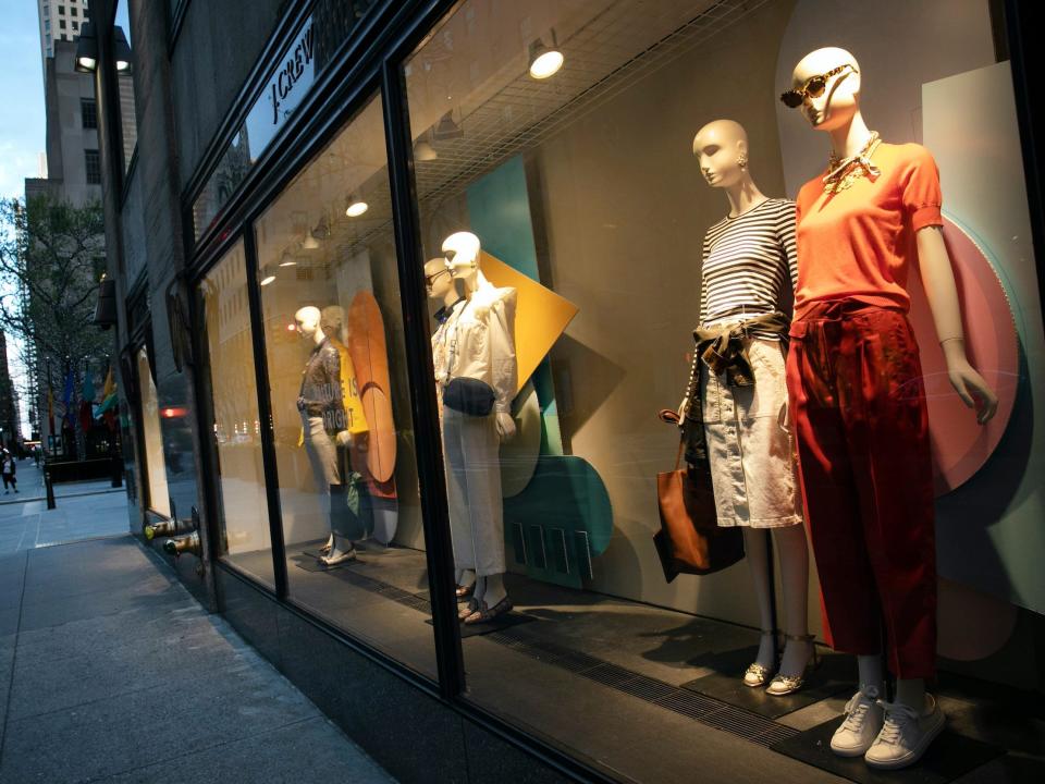Mannequins in the store window at J. Crew at night