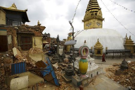 A monk walks past the collapsed monastery and shrines at Swoyambhunath Stupa, a UNESCO world heritage site, after Saturday's earthquake in Kathmandu, Nepal April 28, 2015. REUTERS/Navesh Chitrakar/Files