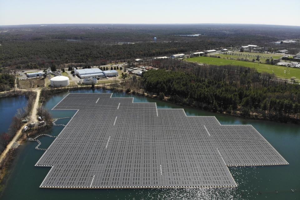 An array of solar panels float on top of a water storage pond in Sayreville, N.J., Monday, April 10, 2023. Floating solar panel farms are beginning to boom in the United States after rapid growth in Asia. They're attractive not just for their clean power and lack of a land footprint, but because they also conserve water by preventing evaporation. (AP Photo/Seth Wenig)