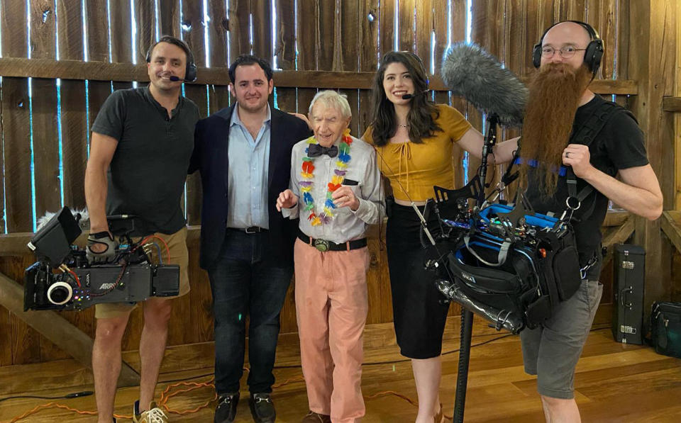 At his 100th birthday party in July, Tucker shared a happy moment with the film crew working on a documentary about his life. (Courtesy Tucker family)