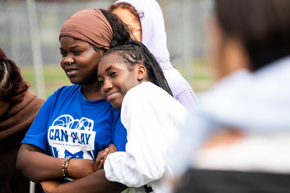 North soccer players Estella Kiza (left) and Lemuna Gurisho (right) embrace during a practice on April 18 in Des Moines.