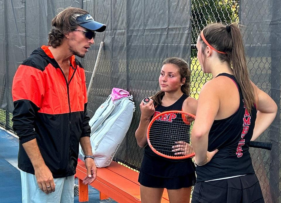 Ryan Deimel, the first-year coach for Cathedral Prep's girls tennis program, speaks with the Ramblers' No. 1 doubles duo of Margaret Prichard and Lilli Beuchert during Thursday's Region 2 dual vs. Fairview at the Salata Tennis Complex. Prichard and Beuchert won, which also helped the Ramblers defeat the Tigers 4-1.