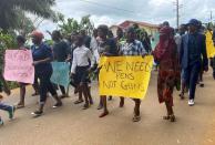 Schoolchildren, their parents and teachers hold a protest after gunmen opened fire at a school, killing at least six children as authorities claim, in Kumba