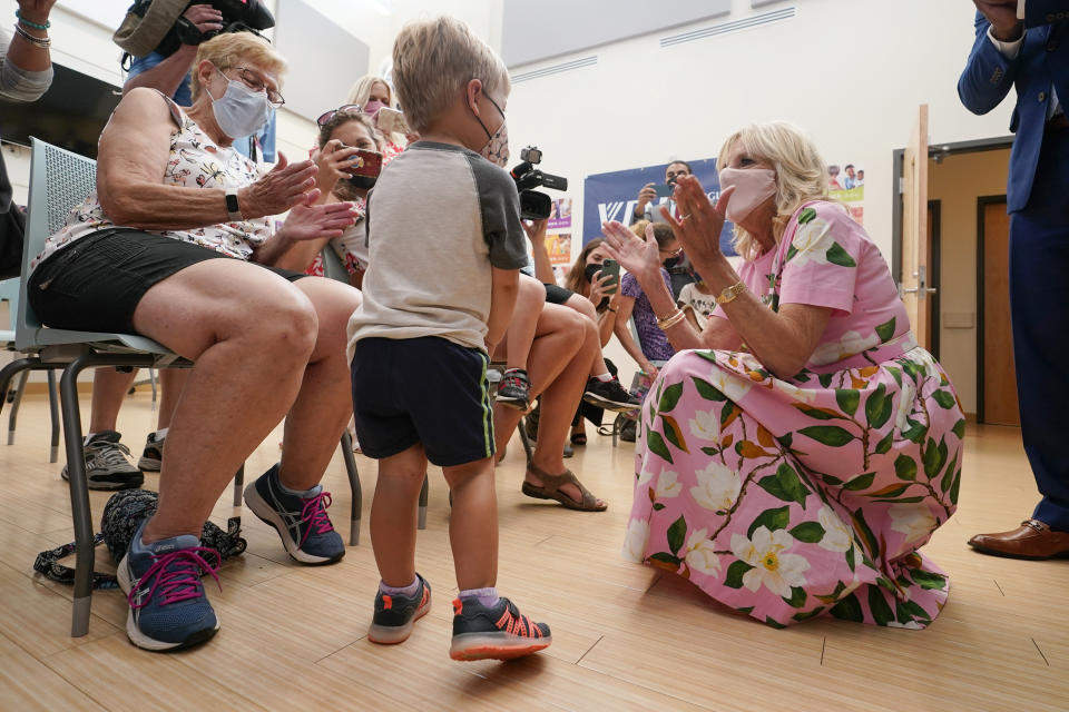 First lady Jill Biden, right, sings Happy Birthday to Henry Crowder, 3, of Richmond, center, as his grandmother, Judy Cunningham, left, watches as she tours a health facility Friday, July 1, 2022, in Richmond, Va. Biden was in town to promote COVID-19 vaccines for small children (AP Photo/Steve Helber)