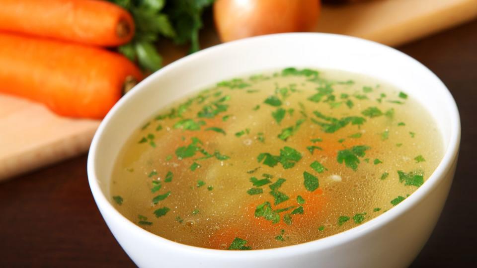 a picture of a bowl of traditional chicken soup served in a bowl over vegetable background,craiova,romania