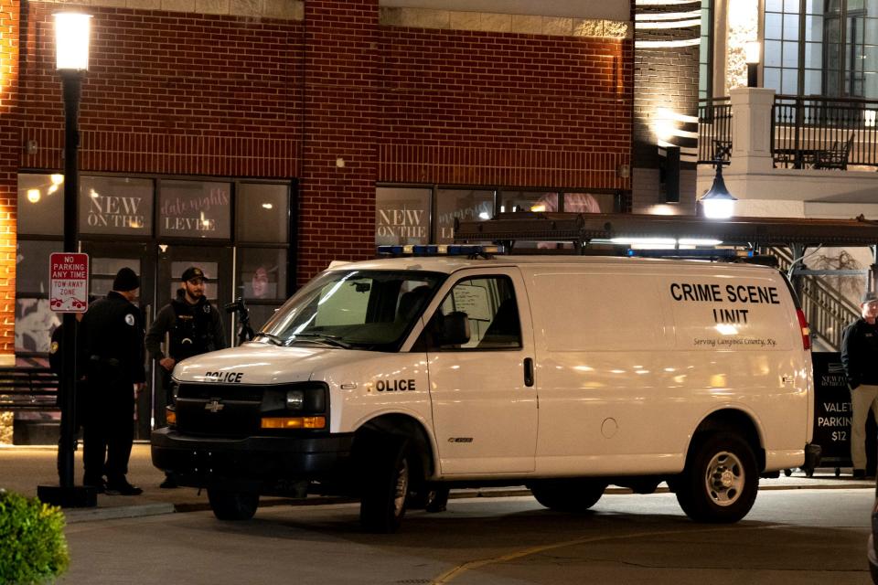 Police work a crime scene at Newport on the Levee in Newport, Ky., on Saturday, March 16, 2024.