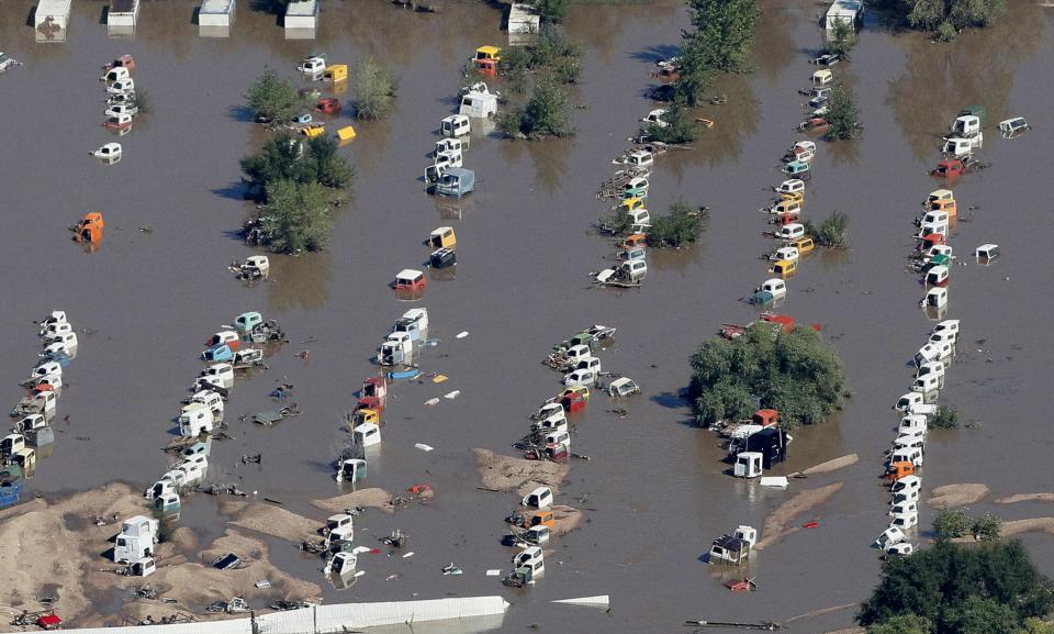 Rows of vehicles lie flooded in Weld County, Colorado