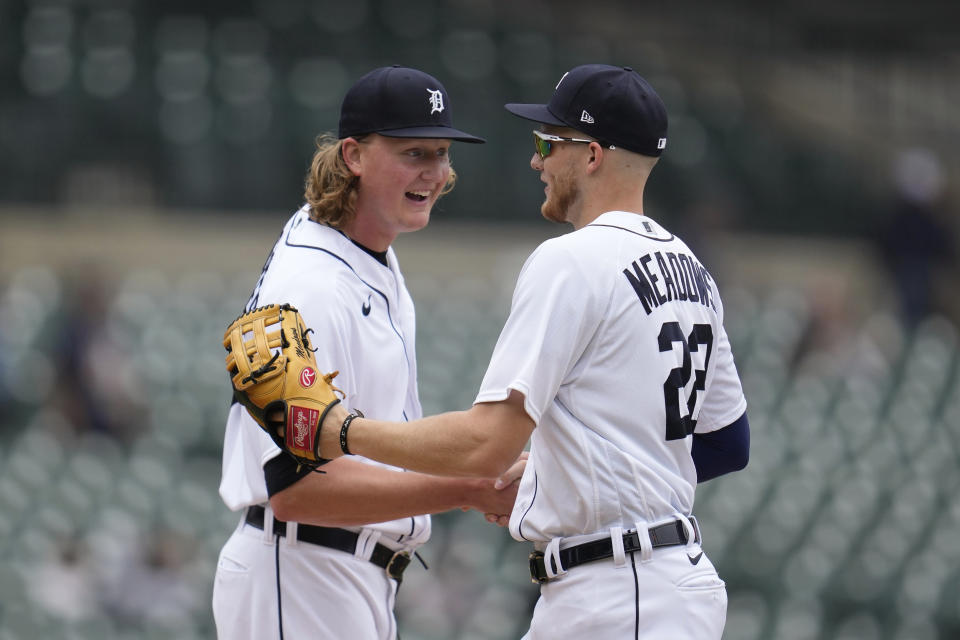 Detroit Tigers relief pitcher Trey Wingenter, left, congratulates Parker Meadows (22) after his catch for the final out at the outfield wall against the Kansas City Royals in the ninth inning of a baseball game that was suspended Wednesday night because of rain, Thursday, Sept. 28, 2023, in Detroit. (AP Photo/Paul Sancya)