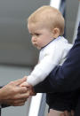 Britain's Prince George's hand is held by New Zealand Governor General Jerry Mateparae as he leaves with his parents Prince William and Kate, the Duchess of Cambridge on a plane bound for Sydney, Australia from Wellington, New Zealand, Wednesday, April 16, 2014. (AP Photo/SNPA, Ross Setford) NEW ZEALAND OUT