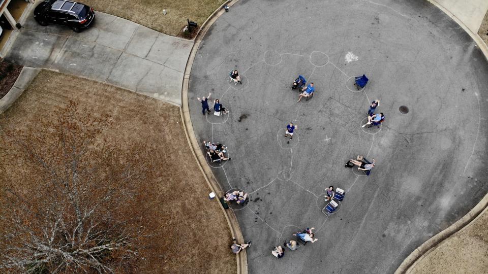 Neighbors in a metro Atlanta neighborhood gathered for a spontaneous block party, after drawing social distancing pods, spaced six feet apart, on the street with chalk. (Photo: Walt Deetz)