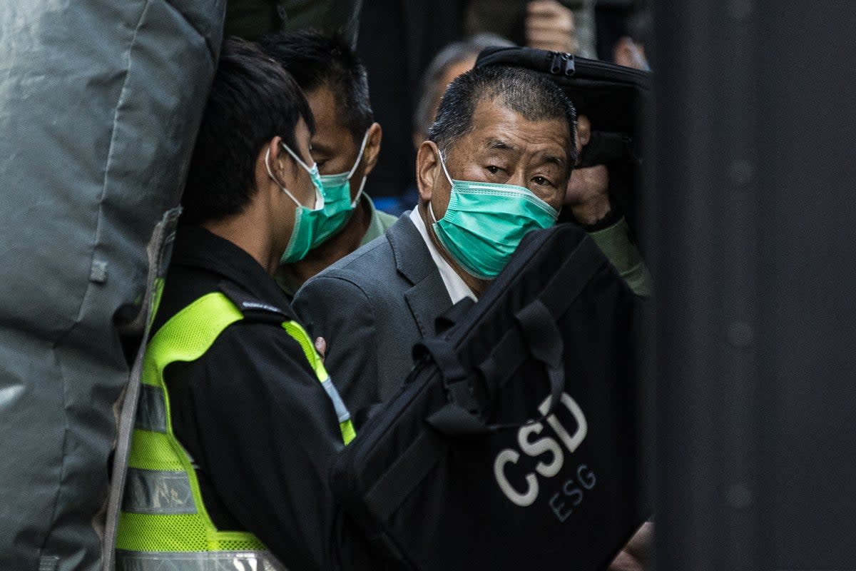 Pro-democracy media tycoon Lai (R) is escorted into a correctional services van outside the Court of Final Appeal in Hong Kong in 2021 (AFP via Getty)