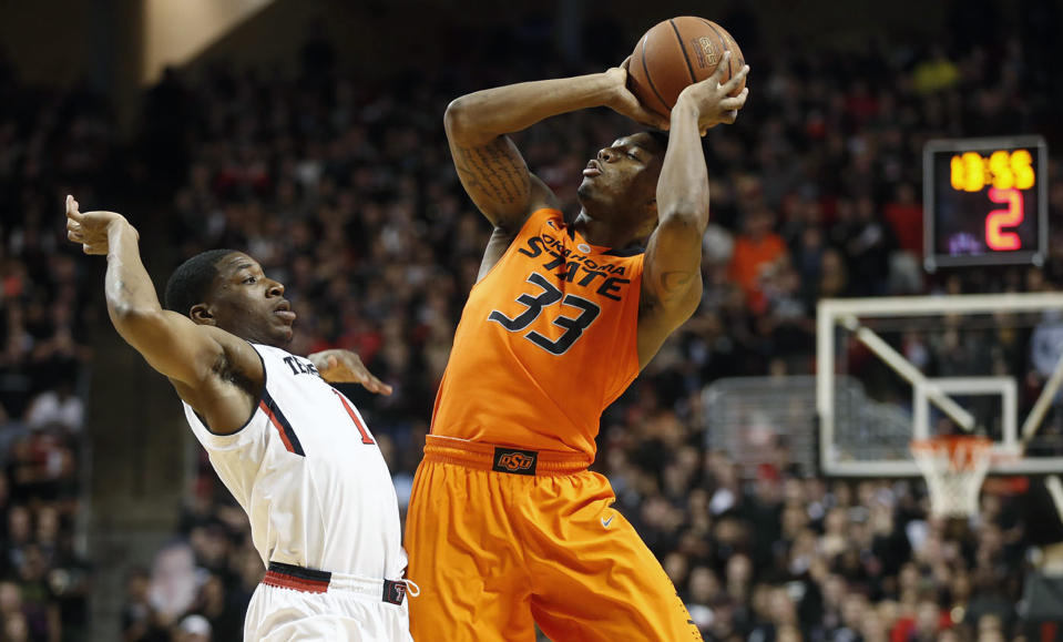 Oklahoma State's Marcus Smart (33) shoots over Texas Tech's Randy Onwuasor (1) during their NCAA college basketball game in Lubbock, Texas, Saturday, Feb, 8, 2014. (AP Photo/Lubbock Avalanche-Journal, Tori Eichberger)