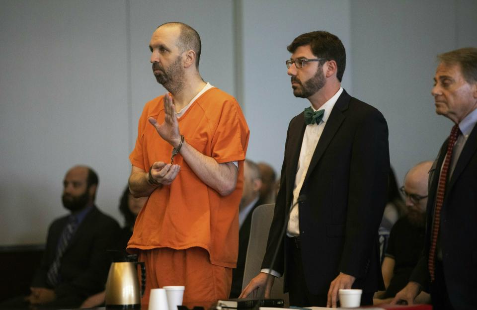 Craig Hicks, in handcuffs,&nbsp;pleaded guilty to three counts of first-degree murder in the 2015 killings of three young Muslims in North Carolina. (Photo: Associated Press)