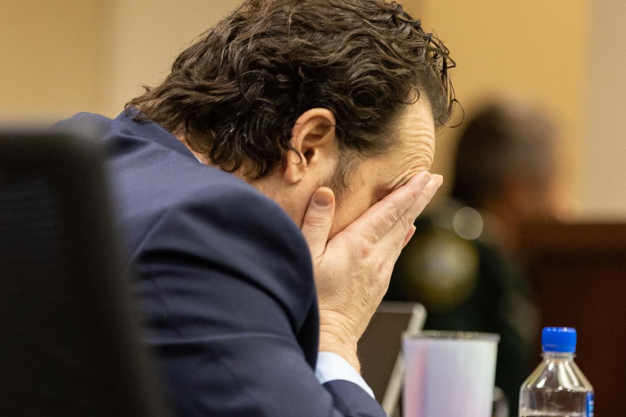 Charlie Adelson rubs his face as he waits for his defense attorney Daniel Rashbaum to present closing arguments in his trial for the murder of Dan Markel on Monday, Nov. 6, 2023.