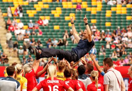 England hoist head coach Mark Sampson as they celebrate their victory over Germany in the third place match of the FIFA 2015 Women's World Cup at Commonwealth Stadium. England defeated Germany 1-0 in extra time. Mandatory Credit: Erich Schlegel-USA TODAY Sports