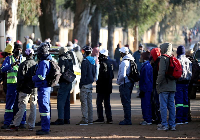 FILE PHOTO: Job seekers stand outside a construction site in Eikenhof, south of Johannesburg,