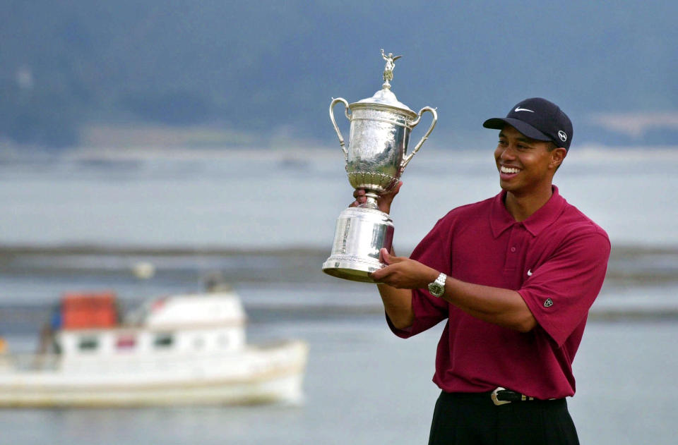 FILE - In this June 18, 2000, file photo Tiger Woods holds the trophy after capturing the 100th U.S. Open Golf Championship at the Pebble Beach Golf Links in Pebble Beach, Calif. For all his feats, however, nothing compares with Woods' 15-shot victory in the 2000 U.S. Open at Pebble Beach, the largest margin in major championship history. (AP Photo/Elise Amendola, File)