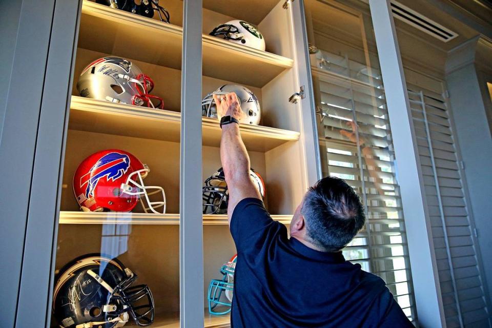 Former Miami Dolphins linebacker Zach Thomas looks at football memorabilia in his Hillsborough home in Florida, Tuesday, January, 21, 2020. Thomas will be considered to be inducted into the NFL Hall of Fame for 2020.