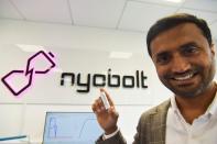 CEO of fast-charging battery startup Nyobolt Sai Shivareddy holds up a battery at the company’s headquarters in Cambridge