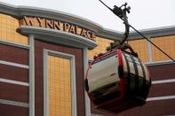 A cable car passes the Wynn Palace, U.S. casino tycoon Steve Wynn's newest resort, before its opening next week in Macau, China August 16, 2016. REUTERS/Bobby Yip