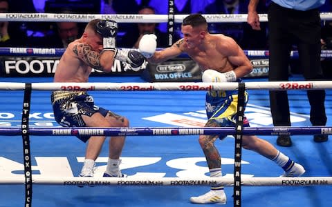 Josh Warrington punches Carl Frampton during the IBF World Featherweight Championship title fight  - Credit: Getty Images