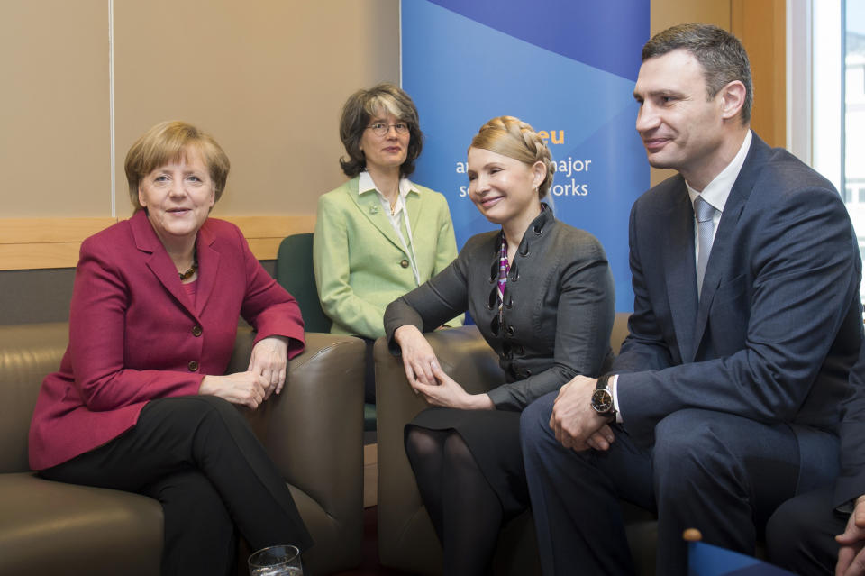 In this picture provided by the German government German Chancellor Angela Merkel, left, meets with Ukrainian politicians Yulia Tymoshenko. second right, and Vitali Klitschko, right, on the occasion of a meeting of the European peoples parties in Dublin, Ireland, Friday, March 7, 2014. Second left is an unidentified interpreter. (AP Photo/German Government/Guido Bergmann)