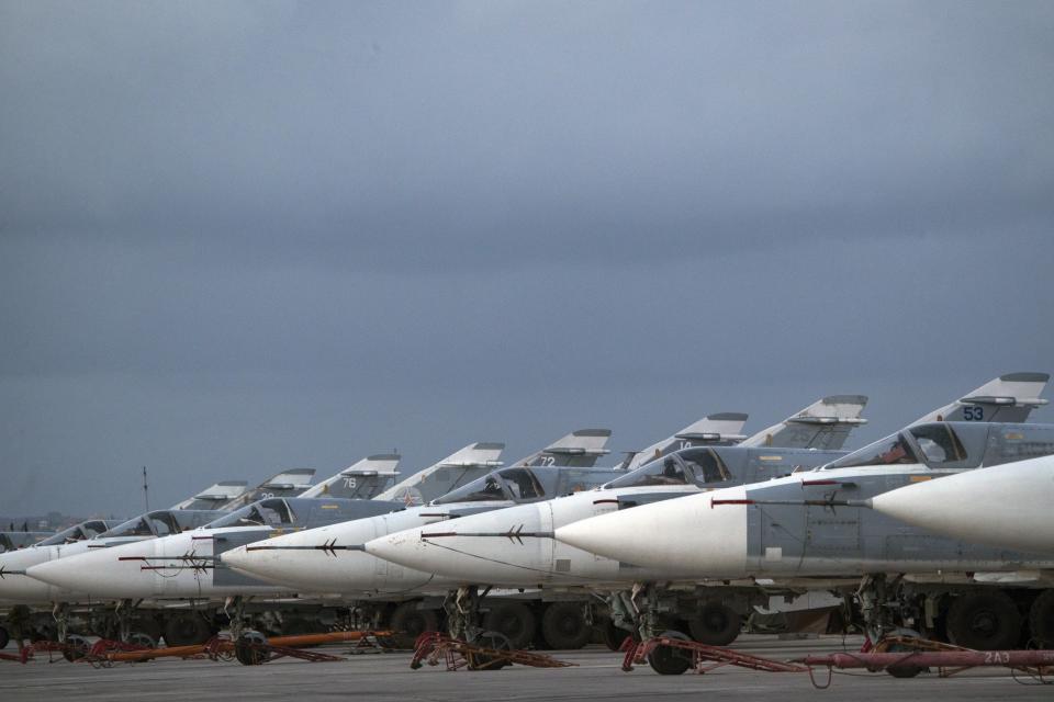 FILE- In this file photo dated Friday, March 4, 2016, Russian warplanes are parked at Hemeimeem air base in Syria. A Russian reconnaissance aircraft was brought down over the Mediterranean Sea as it was returning to its home base inside Syria, killing all 15 people on board, the Russian defense ministry said Tuesday Sept. 18, 2018. (AP Photo/Pavel Golovkin, FILE)