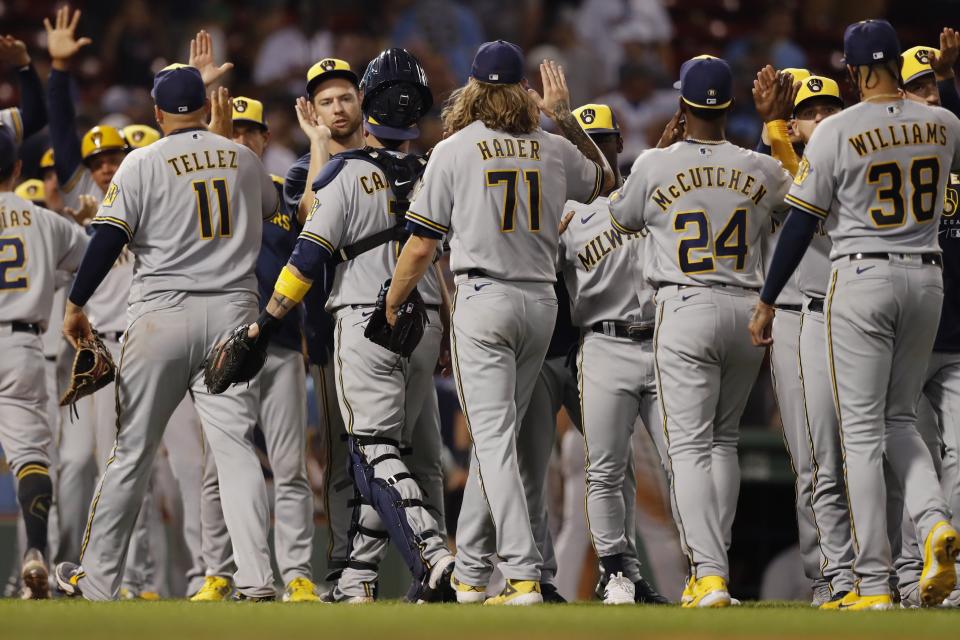 The Milwaukee Brewers celebrate after defeating the Boston Red Sox during a baseball game, Friday, July 29, 2022, in Boston. (AP Photo/Michael Dwyer)