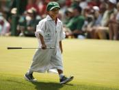 U.S. golfer Tiger Woods' son Charlie carries one of his father's clubs along the fourth hole during the par 3 event held ahead of the 2015 Masters at Augusta National Golf Course in Augusta, Georgia April 8, 2015. REUTERS/Phil Noble