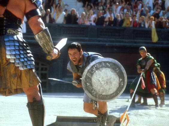 Maximus (Russell Crowe) charges at an opponent in the gladiatorial ring (Universal Pictures)