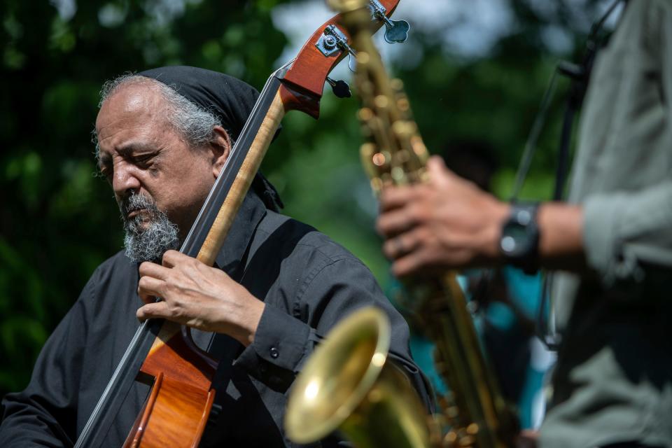 Jaribu Shahid, left, performs next to Marcus Elliot during an event hosted by the Detroit Parks Coalition at Rouge Park in Detroit on Wednesday, May 22, 2024.