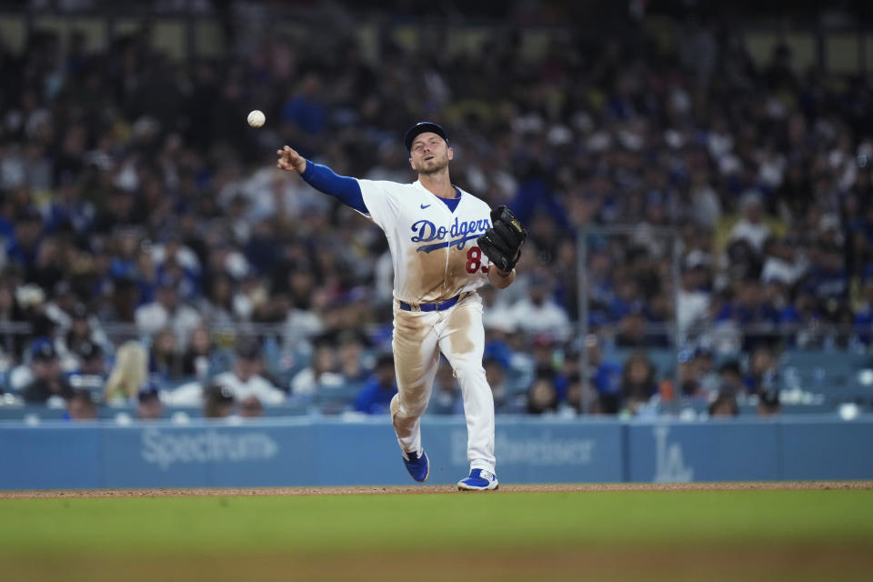 Los Angeles Dodgers' Michael Busch throws to first base for the out on Houston Astros' Mauricio Dubon during the ninth inning of a baseball game Friday, June 23, 2023, in Los Angeles. (AP Photo/Jae C. Hong)