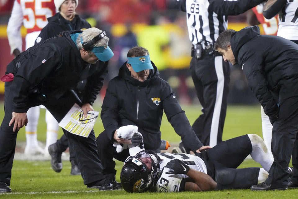 Jacksonville Jaguars wide receiver Christian Kirk (13) is helped after injury against the Kansas City Chiefs during the second half of an NFL divisional round playoff football game, Saturday, Jan. 21, 2023, in Kansas City, Mo. (AP Photo/Charlie Riedel)