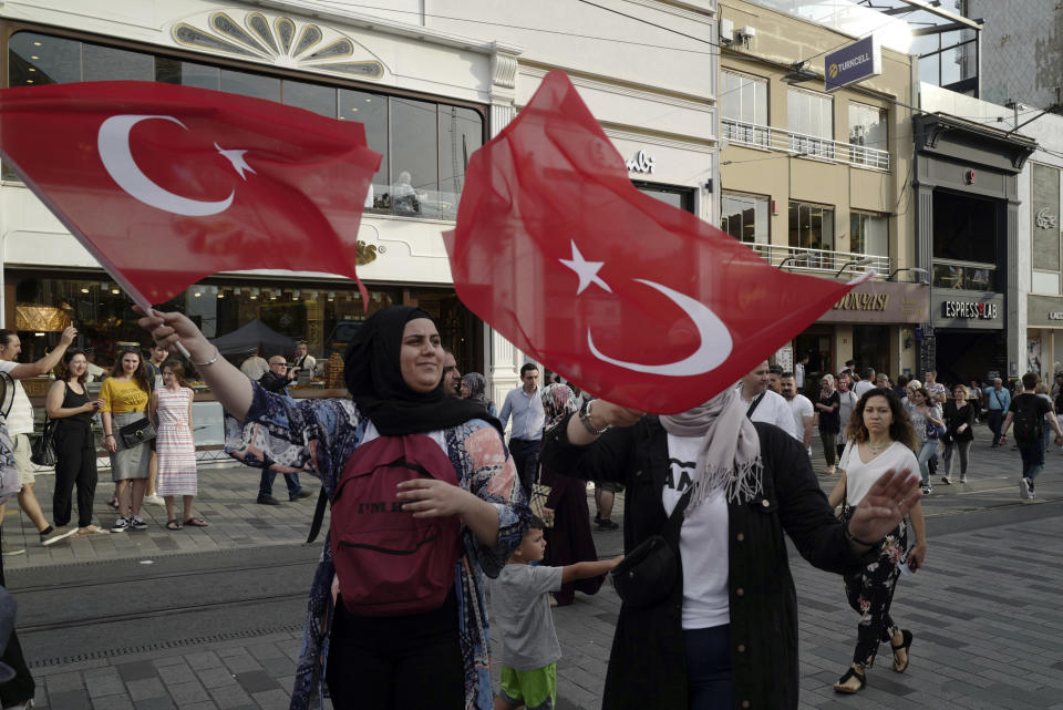 Supporters of ruling Justice and Development Party wave national flags in main Taksim Square in Istanbul, Friday, June 21, 2019, ahead of June 23 re-run of Istanbul elections. Millions of voters in Istanbul go back to the polls for a controversial mayoral election re-run Sunday, as President Recep Tayyip Erdogan's party tries to wrestle back control of Turkey's largest city. (AP Photo/Burhan Ozbilici)