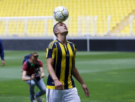 Netherlands striker Robin van Persie poses for the media during his contract-signing ceremony with Turkish club Fenerbahce at Sukru Saracoglu Stadium in Istanbul, Turkey July 14, 2015. REUTERS/Osman Orsal