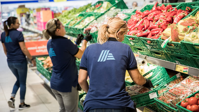 Aldi employees stocking produce 