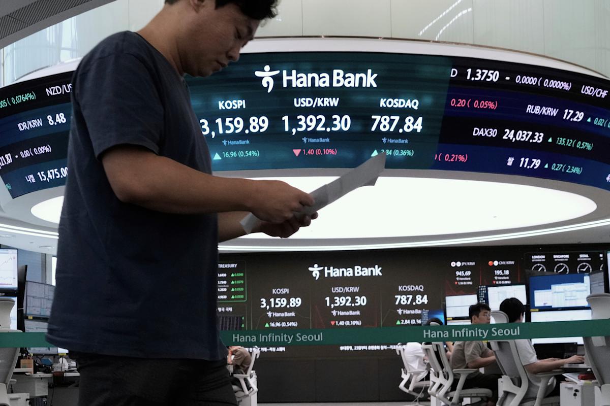 New Photo - Asian shares are mixed and gold sets a fresh record high of over $3,550 per ounce