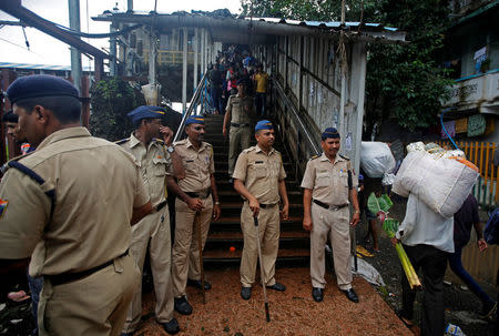 Policemen inspect the site of a stampede at a railway station's pedestrian overbridge in Mumbai, India September 29, 2017. REUTERS/Shailesh Andrade